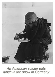 American soldier eats lunch in the snow in Germany.
